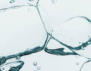 Ghiaccio trasparente e bollicine in acqua, creando un effetto fresco e rinfrescante.