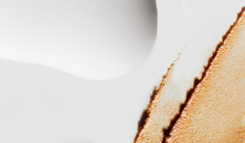 Abstract image featuring a smooth gradient of white and soft beige tones, with a textured, rough edge creating a contrast along one side.