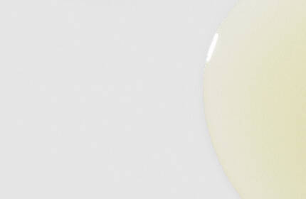 Two amber glass bottles of SkinCeuticals C E Ferulic serum with black droppers, set against a light blue background.