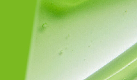 A smooth, glossy texture in white against a vibrant green background, creating a fresh and modern look.