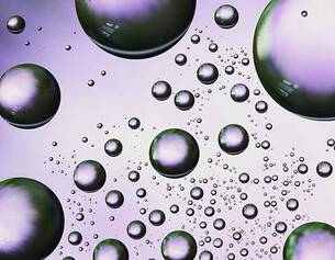 An abstract image of various-sized bubbles with a gradient background, creating a dynamic and fluid visual effect.