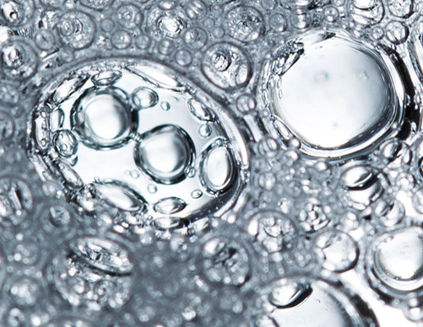 Close-up of bubbles in liquid, showcasing varying sizes and light reflections.