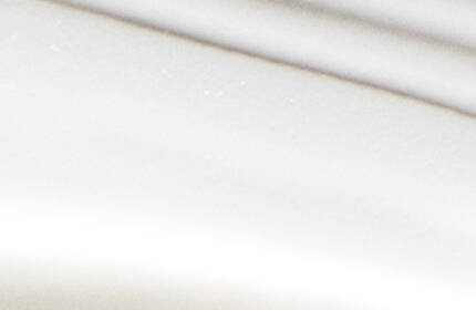 Abstract image featuring smooth, gentle curves of white and light gray tones, creating a sense of flow and movement.
