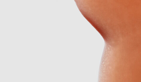 Close-up of smooth, beige cosmetic texture blobs on a light background, showcasing varying sizes and shapes.