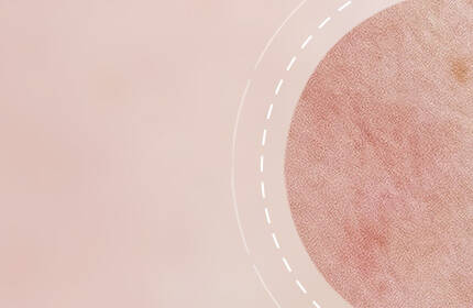Abstract background featuring a soft pink gradient and a circular detail with a textured appearance.