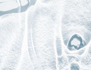 Abstract close-up of a frosty surface, showcasing intricate ice patterns and textures.