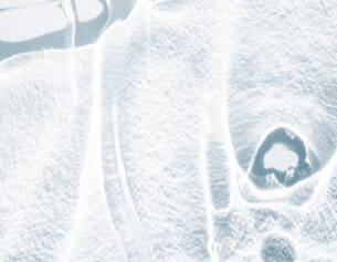 Abstract close-up of a frosty surface, showcasing intricate ice patterns and textures.