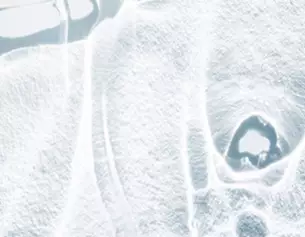 Abstract close-up of a frosty surface, showcasing intricate ice patterns and textures.