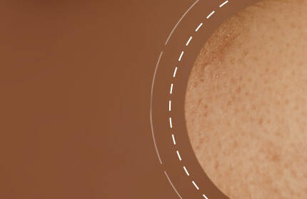 Close-up of a textured skin surface against a warm, brown background, featuring subtle freckles and a soft focus.